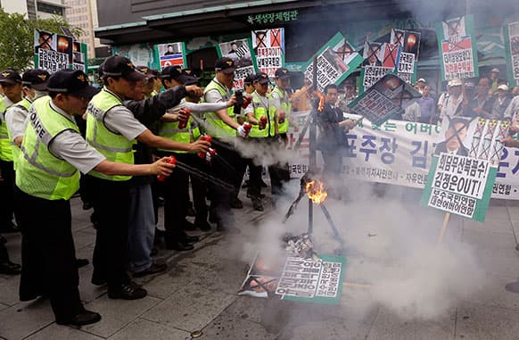 South Korean police officers spray fire extinguishers after protesters burnt an effigy of North Korean leader Kim Jong Un and its flag during an anti-North Korea rally denouncing the cancellation of Koreas high-level talks in downtown Seoul, South Korea.