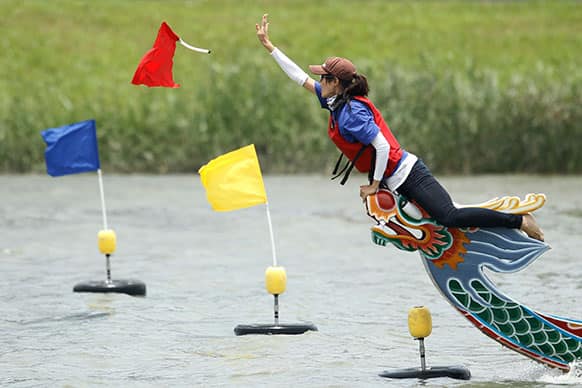 The winning team tosses the flag during the annual Chinese traditional Dragon Boat Festival races in Taipei, Taiwan.