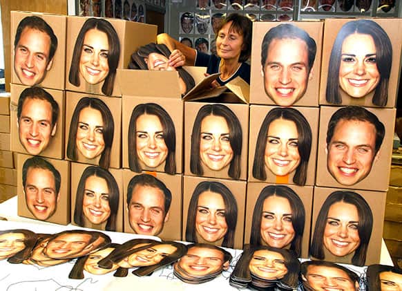 Pam Cooper loads boxes of Prince William & Kate, Duchess of Cambridge masks ready for dispatch at the company works in England. Mask-arade are in overdrive printing masks of Kate & William for the street parties that will follow the announcement of the birth of the Royal baby, expected in July.