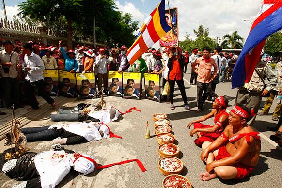 Cambodian villagers offer a prayer during rally in front of the National Assembly in Phnom Penh, Cambodia.