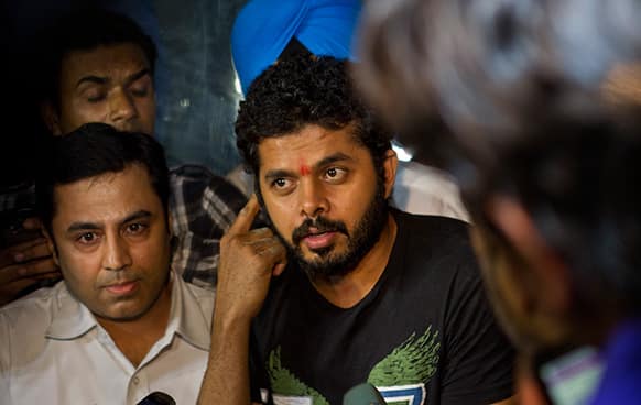 Indian cricket player Shantakumaran Sreesanth, center, who on May 16 was arrested along with two other players on spot fixing charges, talks to the media after he was released from prison in New Delhi.