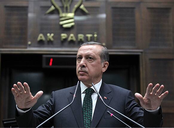Turkey`s Prime Minister Recep Tayyip Erdogan gestures as he addresses lawmakers and supporters of his ruling Justice and Development Party at the parliament in Ankara, Turkey.