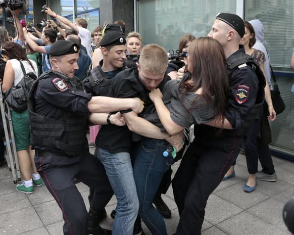 Police officers detain gay rights activists as they gathered near the State Duma, Russia`s lower parliament chamber, in Moscow, Russia.