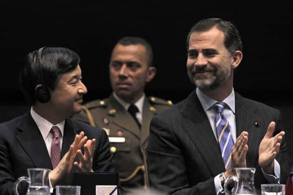 Spain`s Crown Prince Felipe, right, and Japan`s Crown Prince Naruhito, left, clap hands during the opening of Spanish-Japanese Business Cooperation Meeting at the House of Mint in Madrid.