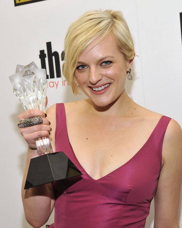 Elisabeth Moss poses backstage with her award for best actress in a movie or mini-series for