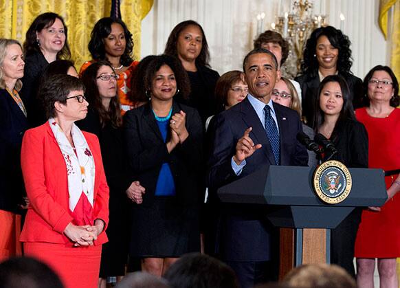 White House senior adviser Valerie Jarrett, left, and others, listens as President Barack Obama speaks in the East Room of the White House in Washington.