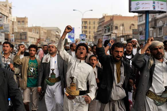 Yemeni Shiite Hawthis chant slogans as they march during a demonstration demanding the release of political detainees near intelligence headquarters in Sanaa, Yemen.