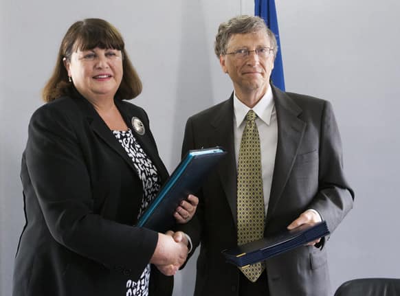 Bill Gates, shake hands with European Commissioner for Research and Innovation Maire Geoghegan-Quinn after they signed an medical agreement for research support of the Global Fund to fight Tuberculosis and Malaria at the conclusion of their meeting, in Paris.