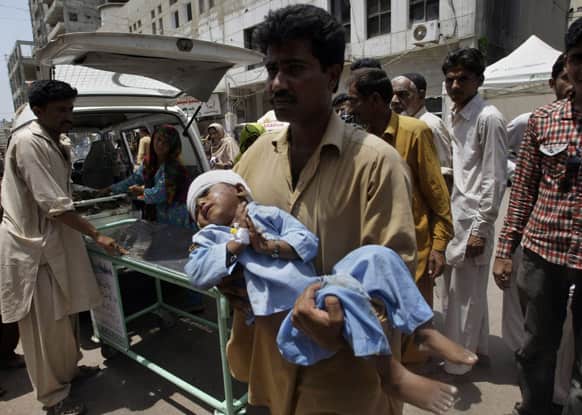 A Pakistani child who was injured in a cross firing incident of two rival groups is brought to a local hospital for treatment in Karachi.