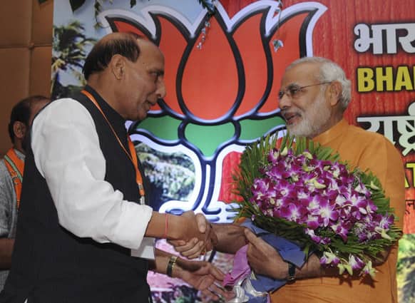 Narendra Modi, is greeted by Bharatiya Janata Party President Rajnath Singh during the BJP’s national executive meeting at Panaji, Goa.