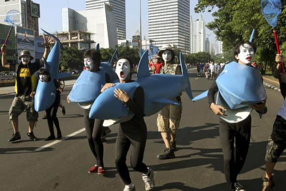 Activists wear shark costumes during a World Wildlife Fund rally against the slaughtering of sharks in Jakarta, Indonesia.