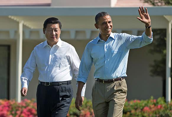 President Barack Obama, right, walks with Chinese President Xi Jinping at the Annenberg Retreat of the Sunnylands estate in Rancho Mirage, Calif.