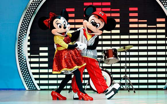 Popular Disney characters Minnie Mouse, left, and Micky Mouse perform during