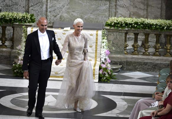 Swedish pop group Roxette singer Marie Fredriksson and husband Mikael Boyloys arrive at the Royal Chapel for the wedding of Sweden`s Princess Madeleine and Christopher O`Neill, in Stockholm.