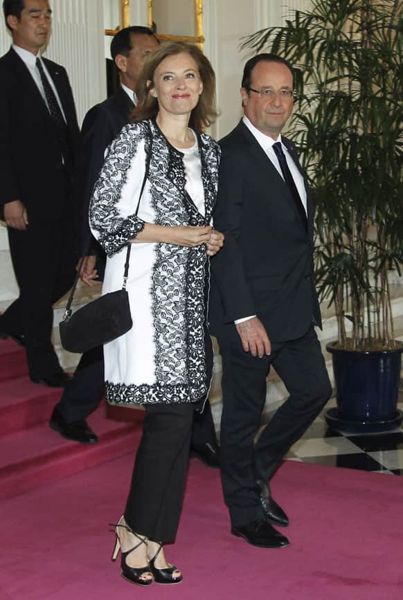 French President Francois Hollande, right, walks with his companion Valerie Trierweiler at the Akasaka Palace state guesthouse in Tokyo.