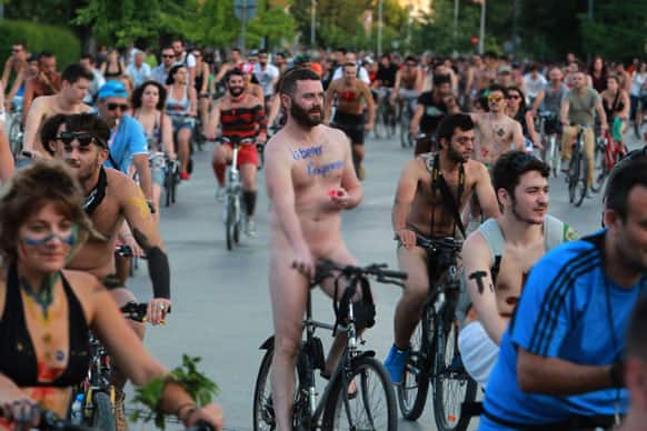 Protesters some naked with their body painted during a bicycle protest in the northern port city of Thessaloniki, Greece.
