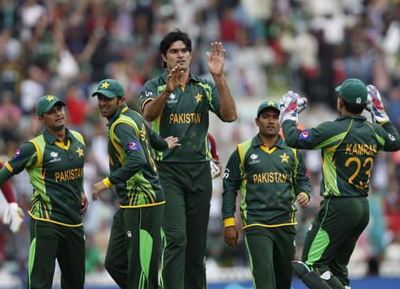 Muhammad Irfan celebrates with teammates the wicket of West Indies` Johnson Charles caught by teammate Wahab Riaz during their ICC Champions Trophy group B cricket match at the Oval cricket ground in London.