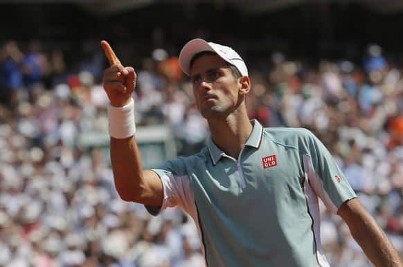 Serbia`s Novak Djokovic gestures as he wins the fourth set against Spain`s Rafael Nadal during their semifinal match of the French Open tennis tournament at the Roland Garros stadium in Paris.