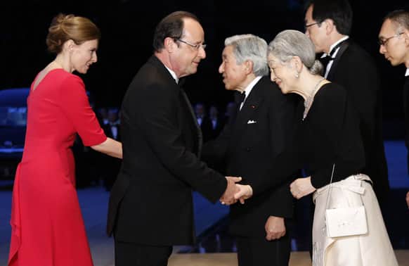 French President Francois Hollande and his partner Valerie Trierweiler are greeted by Japanese Emperor Akihito and Empress Michiko, upon their arrival for a dinner reception at the Imperial Palace in Tokyo.