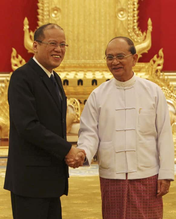 Philippine President Benigno S. Aquino III, left, shakes hand with Myanmar President Thein Sein as they pose for photos prior to their meeting at the Presidential Palace in Naypyitaw, Myanmar.