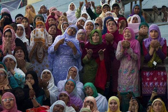 Kashmiri Muslim women pray as a head priest, unseen, displays a holy relic believed to be the hair from the beard of Prophet Mohammed, on the occasion of Mehraj-u-Alam, at the Hazratbal Shrine on the outskirts of Srinagar.