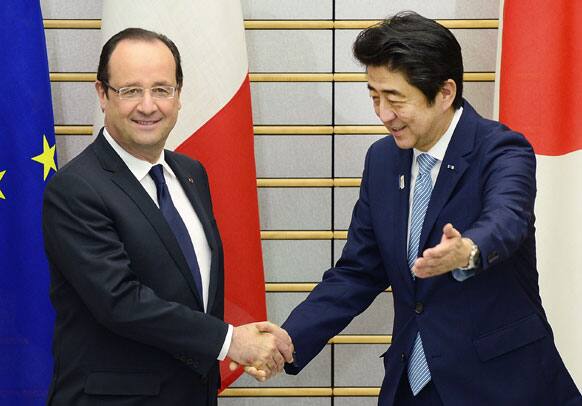 French President Francois Hollande, shakes hands with Japanese Prime Minister Shinzo Abe, prior to their summit meeting at Abe`s official residence in Tokyo.