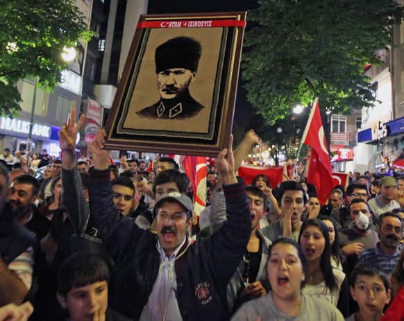 Thousands of Turkish protesters, holding national flags and portraits of Turkey`s founder Mustafa Kemal Ataturk, march in Turkish capital, Ankara.