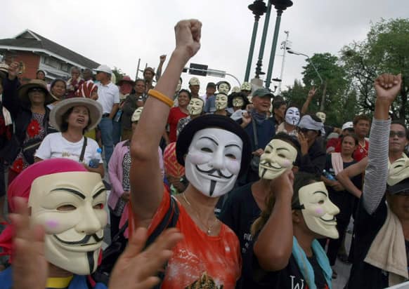Thai activists wear masks while chanting slogans during a protest outside the Government House in Bangkok, Thailand.