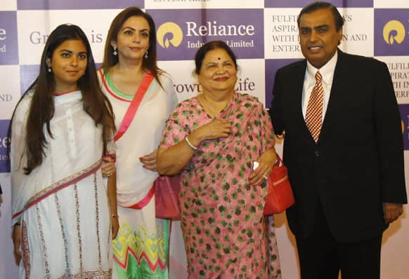 Reliance Industries Chairman Mukesh Ambani poses for photographs with mother Kokilaben Ambani, wife Nita Ambani and daughter Isha during the company`s annual general meeting in Mumbai.