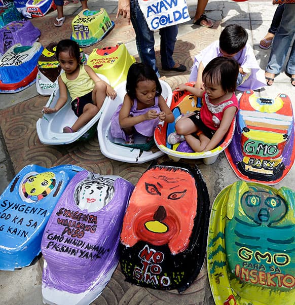 Children display baby tubs painted with protest messages during a rally on World Environment Day at suburban Quezon city northeast of Manila, Philippines.