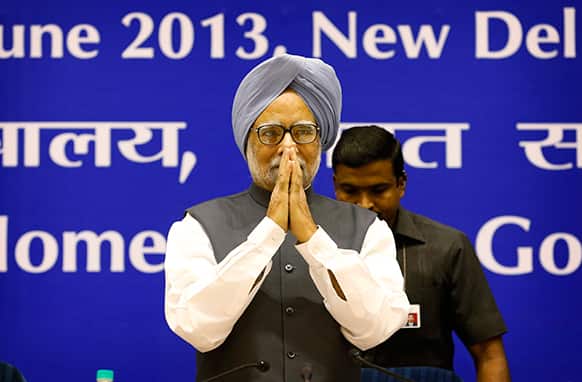 Prime Minister Manmohan Singh greets people upon arrival for a conference of the Chief Ministers of various Indian states on Internal Security in New Delhi, India.
