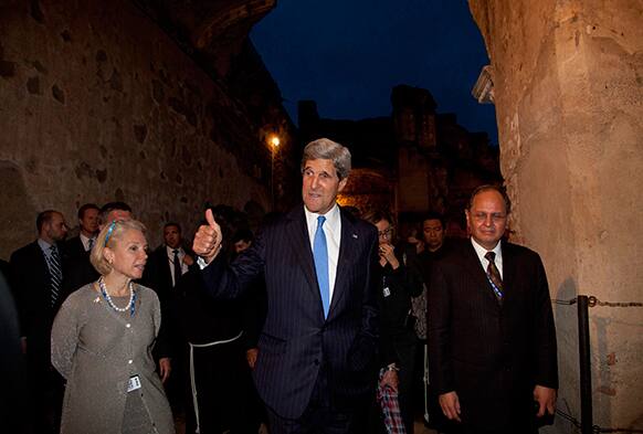 US Secretary of State John Kerry gives a thumbs up to press photographers after visiting San Francisco Church in Antigua Guatemala.