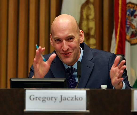Gregory Jaczko, former Chairman of the Nuclear Regulatory Commission, talks with event organizers before the start of a conference in San Diego at the chambers of County Supervisors.