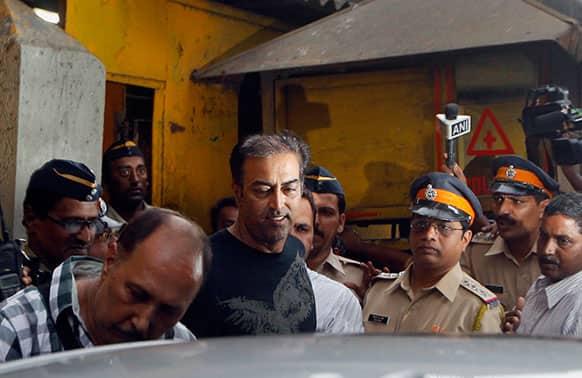 Bollywood actor Vindu Dara Singh, center, comes out of a jail after he was granted bail by a Mumbai court for his alleged involvement in spot fixing in cricket, in Mumbai.