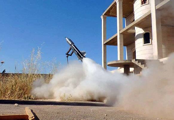 This citizen journalism image provided by Edlib News Network, ENN, which has been authenticated based on its contents and other AP reporting, shows a locally made rocket being fired by Syrian rebels, in Idlib province, northern Syria.
