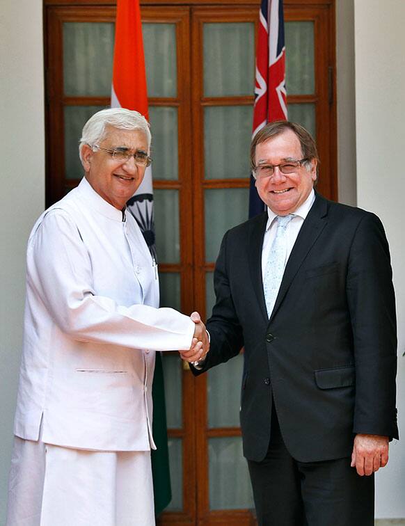 New Zealand`s Foreign Minister Murray McCully, right, and Indian External Affairs Minister Salman Khurshid, pose for the media as they arrive for a meeting in New Delhi.