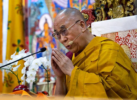 Tibetan spiritual leader the Dalai Lama prays during the last day of a four-day religious talk at the Tsuglakhang temple in Dharmsala.