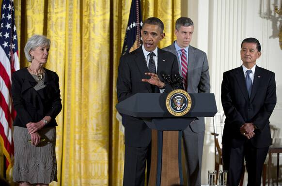 Barack Obama, accompanied by, Health and Human Services Secretary Kathleen Sebelius, Education Secretary Arne Duncan, and Veterans Affairs Secretary Eric Shinseki. gestures while speaking during opening remarks of the White House mental health conference, White House in Washington.