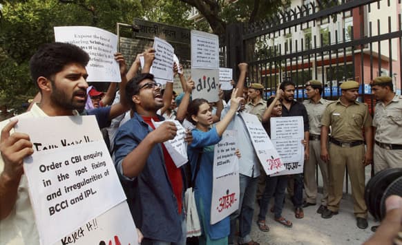 All India Students` Association activists shout slogans demanding that the ongoing spot-fixing scandal in the IPL cricket be investigated by the Central Bureau of Investigation during a protest outside the Sports Ministry office in New Delhi.
