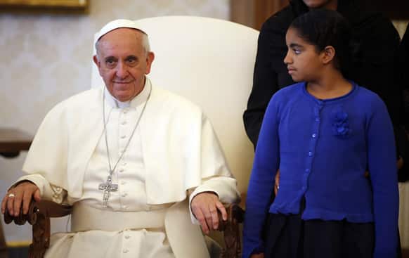 Pope Francis sits as the daughter of Cape Verde`s President Jorge Carlos Fonseca (unseen) looks at him during a private audience at the Vatican.