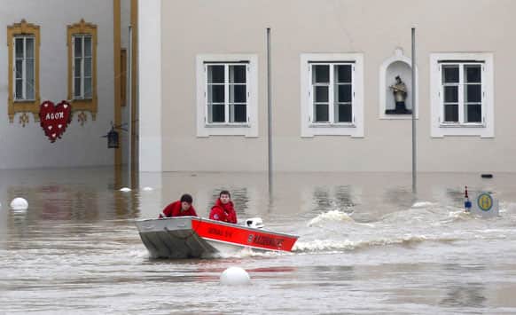 Members of the red cross make their way by boats in the flooded street in the centre of Passau, southern Germany.