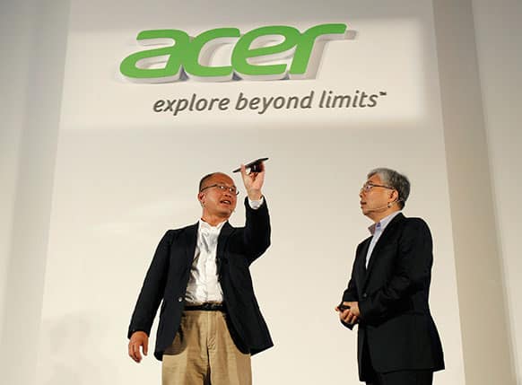 Acer Inc. Associated Vice President of Mobile Computing David Lee, left, describes features of the new smartphone Liquid S1 to President Jim Wong at an international press conference on the eve of the opening of Computex, one of the world`s largest IT exhibitions, in Taipei, Taiwan.