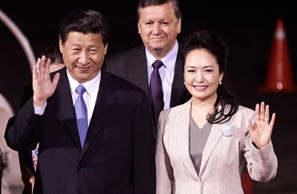 China`s President Xi Jinping and his wife Peng Liyuan wave to reporters upon their arrival to San Jose, Costa Rica. Xi is embarked on a tour of the Americas, visiting Trinidad & Tobago, Costa Rica Mexico and the US.