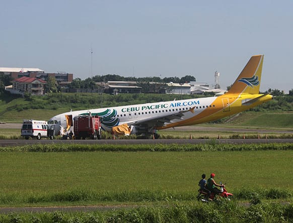 A Cebu Pacific Airbus A320 passenger plane sits on the side of a runway Monday, June 3, 2013 after it overshot the runway upon landing at Davao International Airport in southern Philippines on Saturday evening.