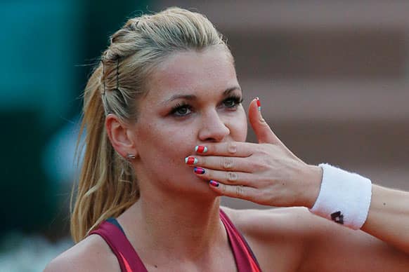 Poland`s Agniezska Radwanska blows a kiss to spectators after defeating Serbia`s Ana Ivanovic in their fourth round match at the French Open tennis tournament.