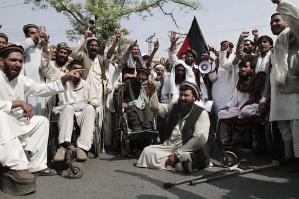 Afghan disabled people chant slogans during a demonstration in front of the governor house of Jalalabad, east of Kabul, Afghanistan.