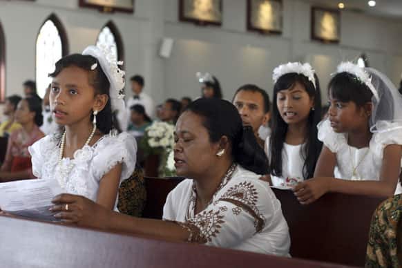 Indonesian girls pray during a mass for receiving the first communion at catholic church in Nusa Dua, Bali, Indonesia.