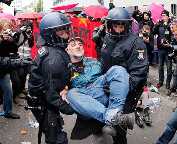 A demonstrator is carried away by German police during an anti capitalism Blockupy protest in Frankfurt.