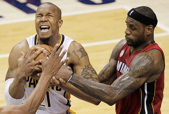 Indiana Pacers forward David West battles for the ball with Miami Heat forward LeBron James during the second half of Game 6 of the NBA Eastern Conference basketball finals in Indianapolis.