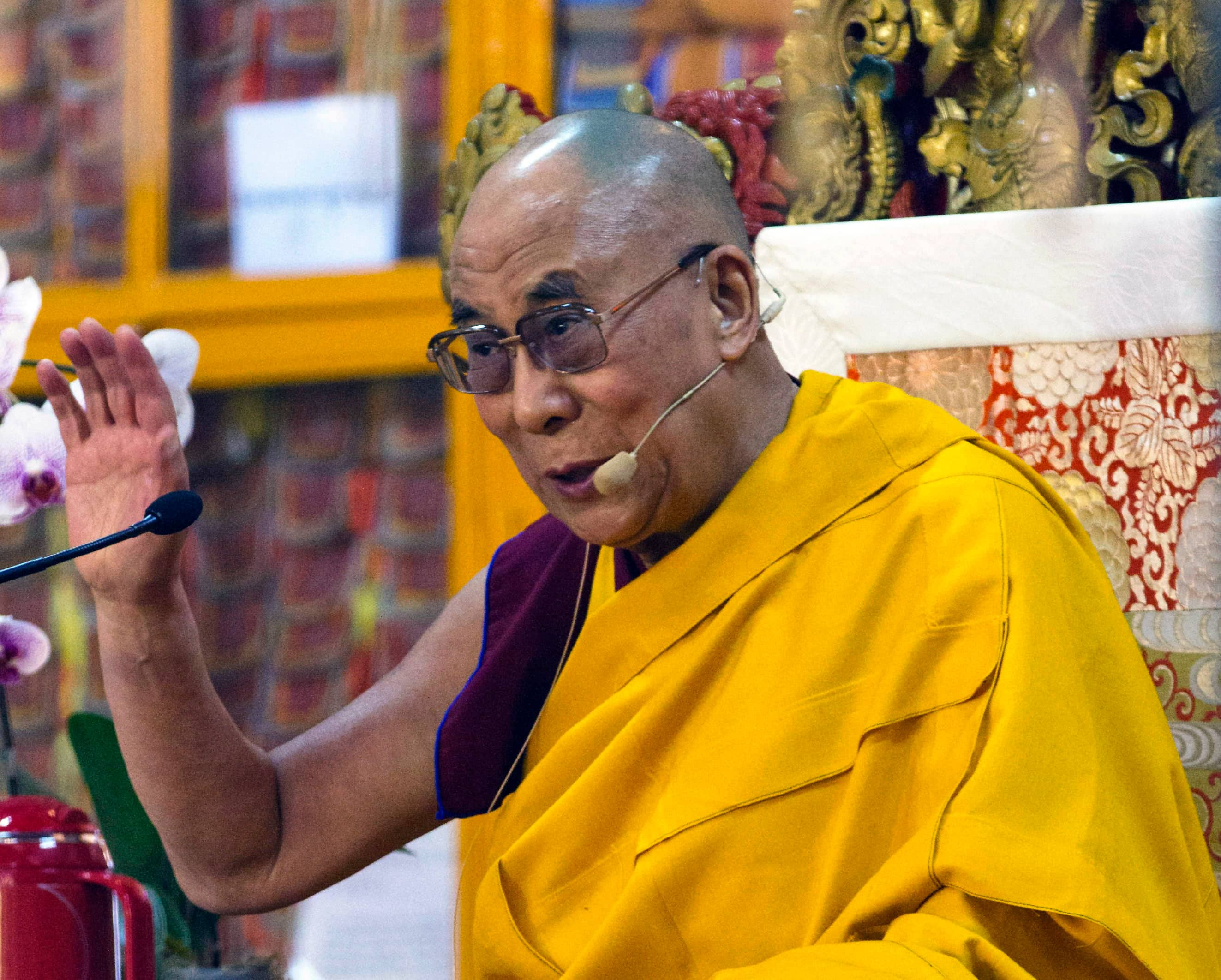 Tibetan spiritual leader the Dalai Lama gestures during a religious talk at the Tsuglakhang temple in Dharmsala.